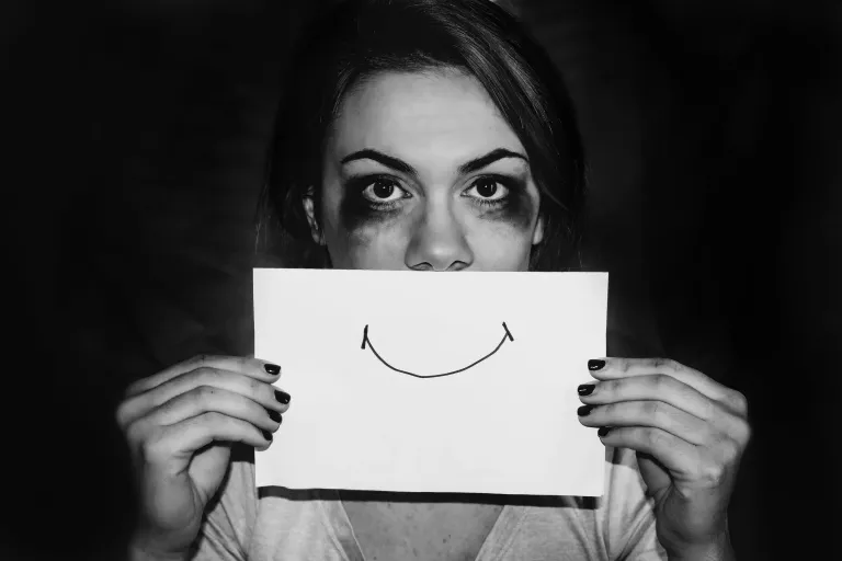Dark moody image typically associated with self-harm in media, contrasting with article's approach