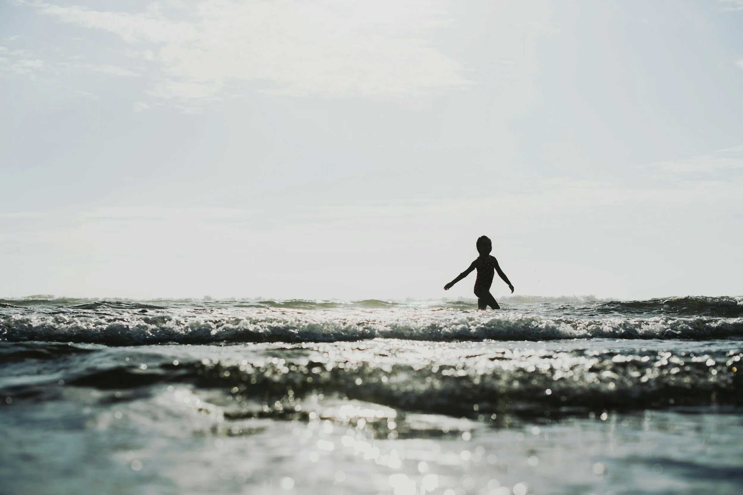 Child playing in the sea